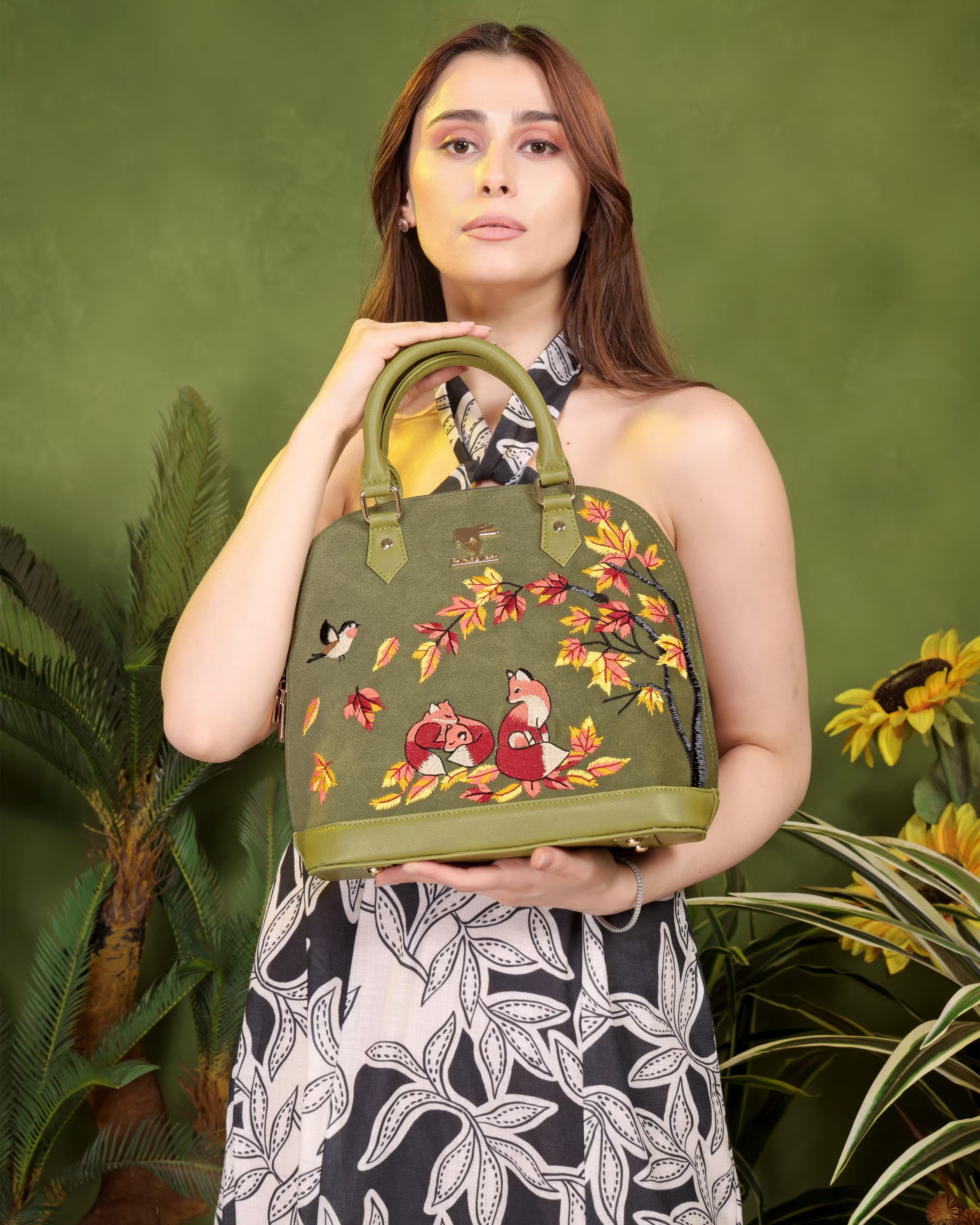 Olive green floral vegan leather top handle bag from the Autumn Whisper Collection placed on a muted background
