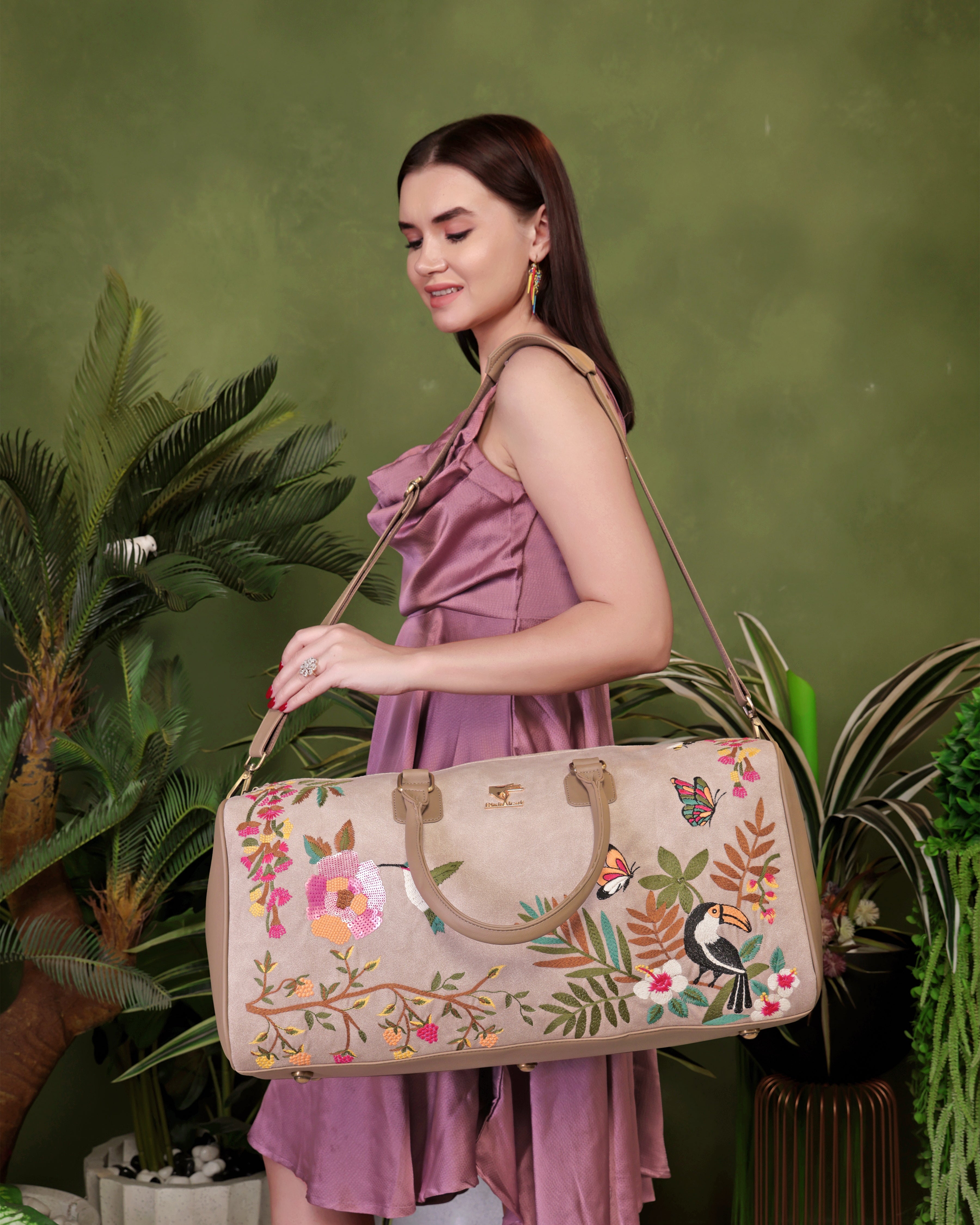 Beige Mystic Garden embroidered duffel bag.