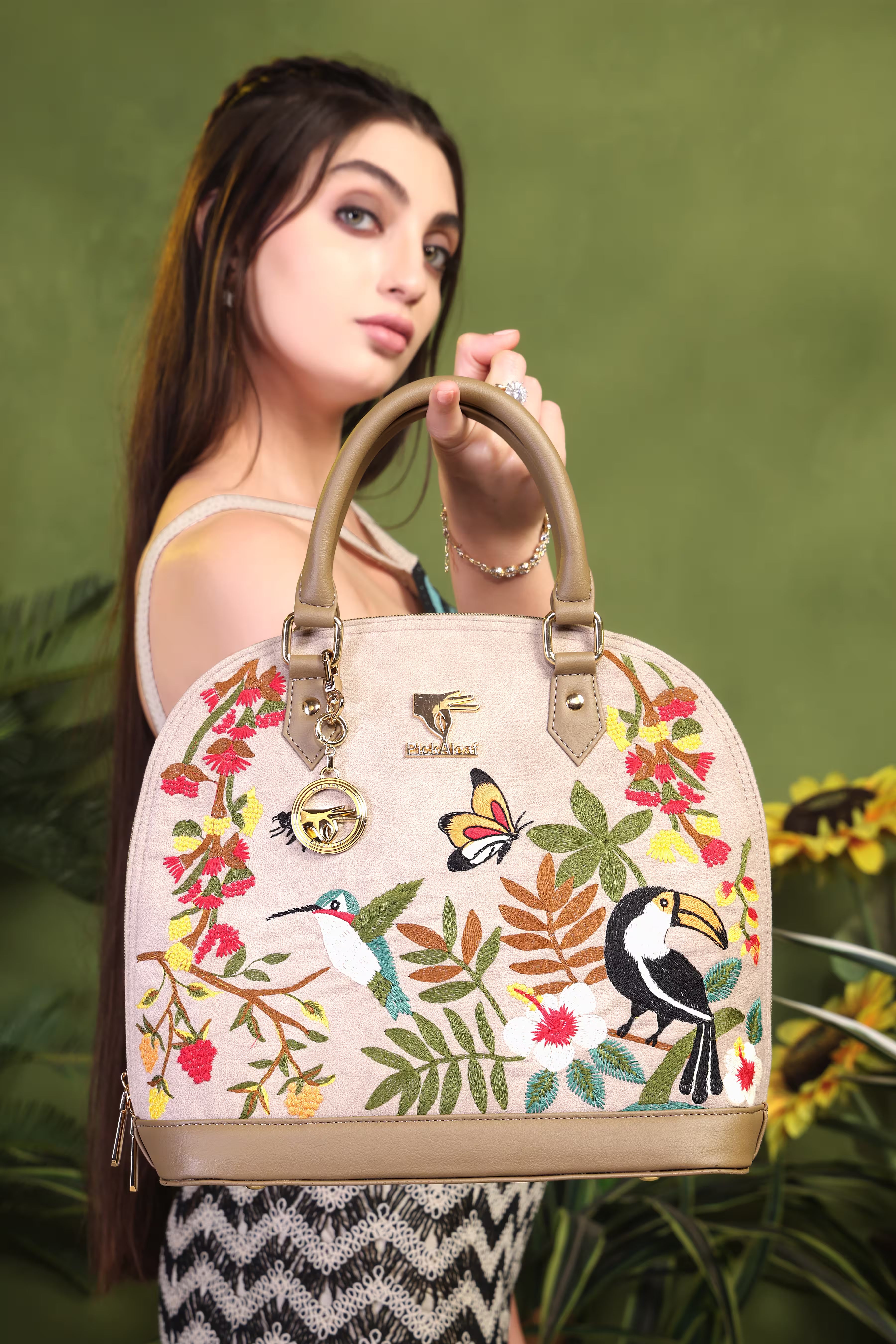 Beige floral vegan leather top handle bag from the Mystic Garden Collection displayed on a plain surface