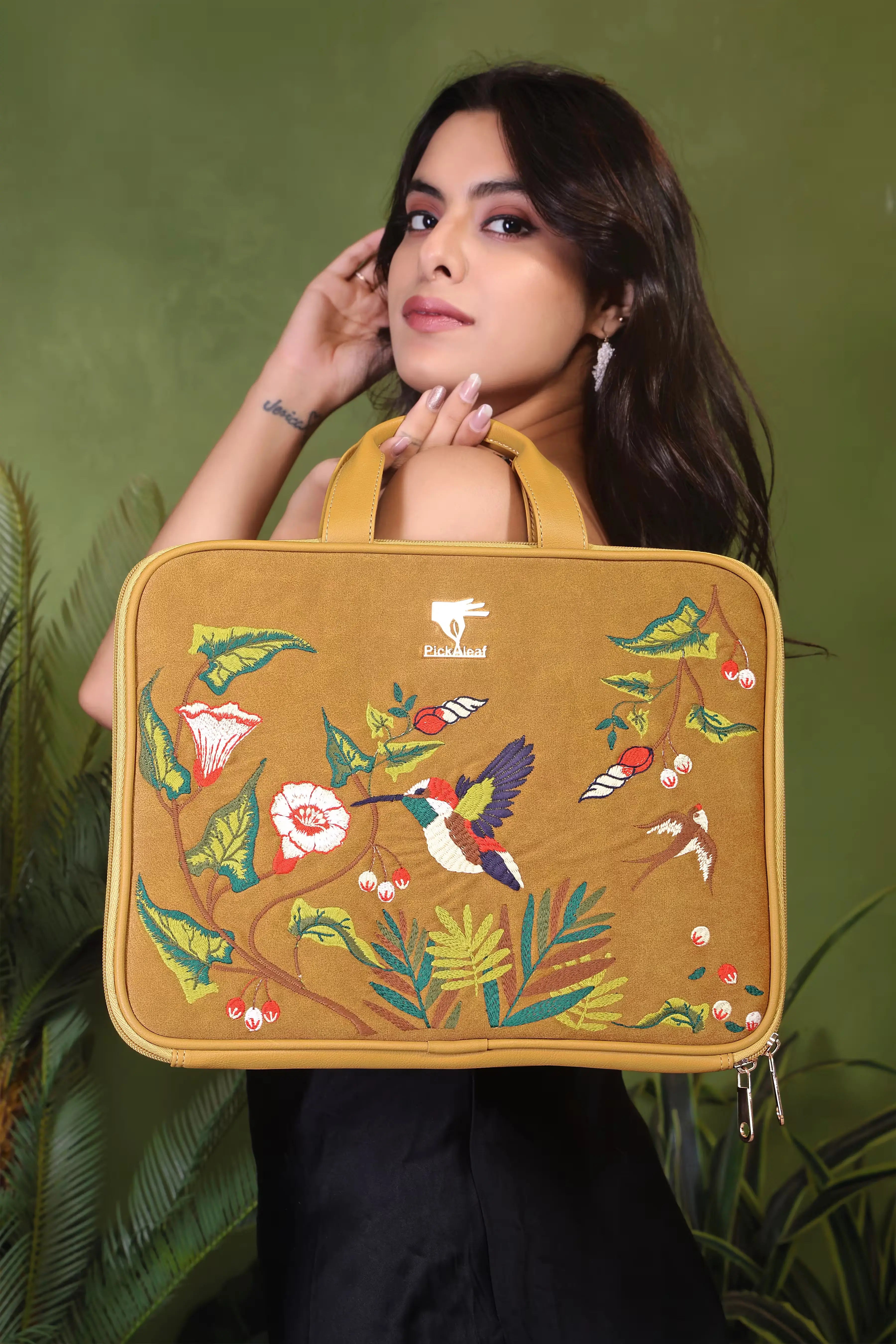 Gold Flora embroidered laptop sleeve.