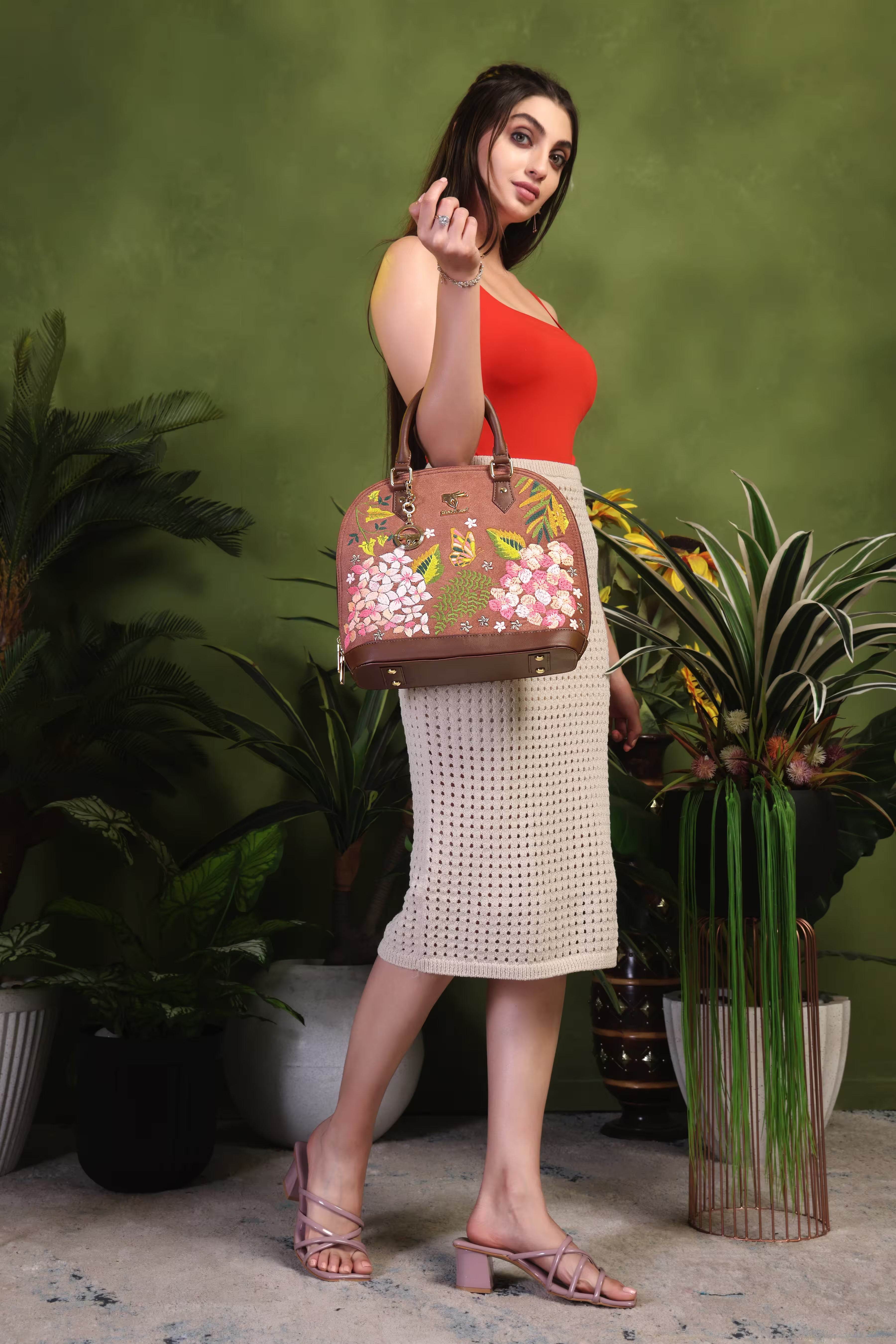 Brown floral vegan leather top handle bag from the Blossom Wood Collection placed on a clean background