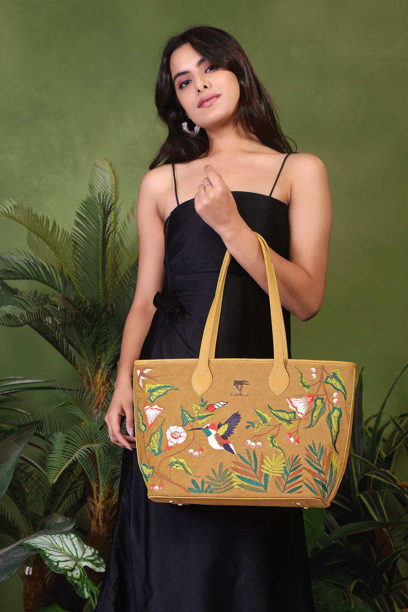 Gold Flora embroidered tote bag for travel and daily carry.