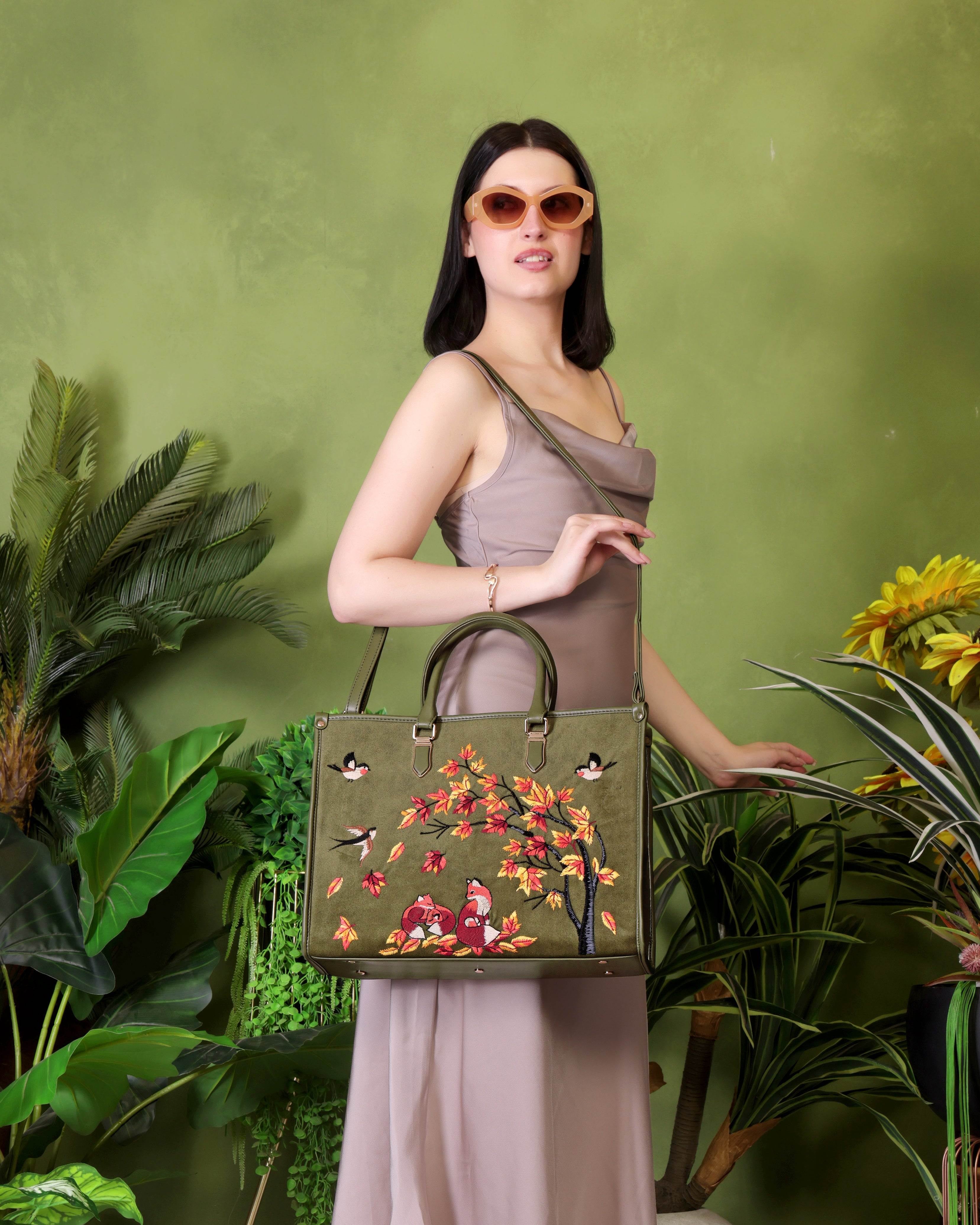 Olive green travel tote bag for women in cruelty free vegan leather by PickAleaf with embroidered design for travel and weekend use