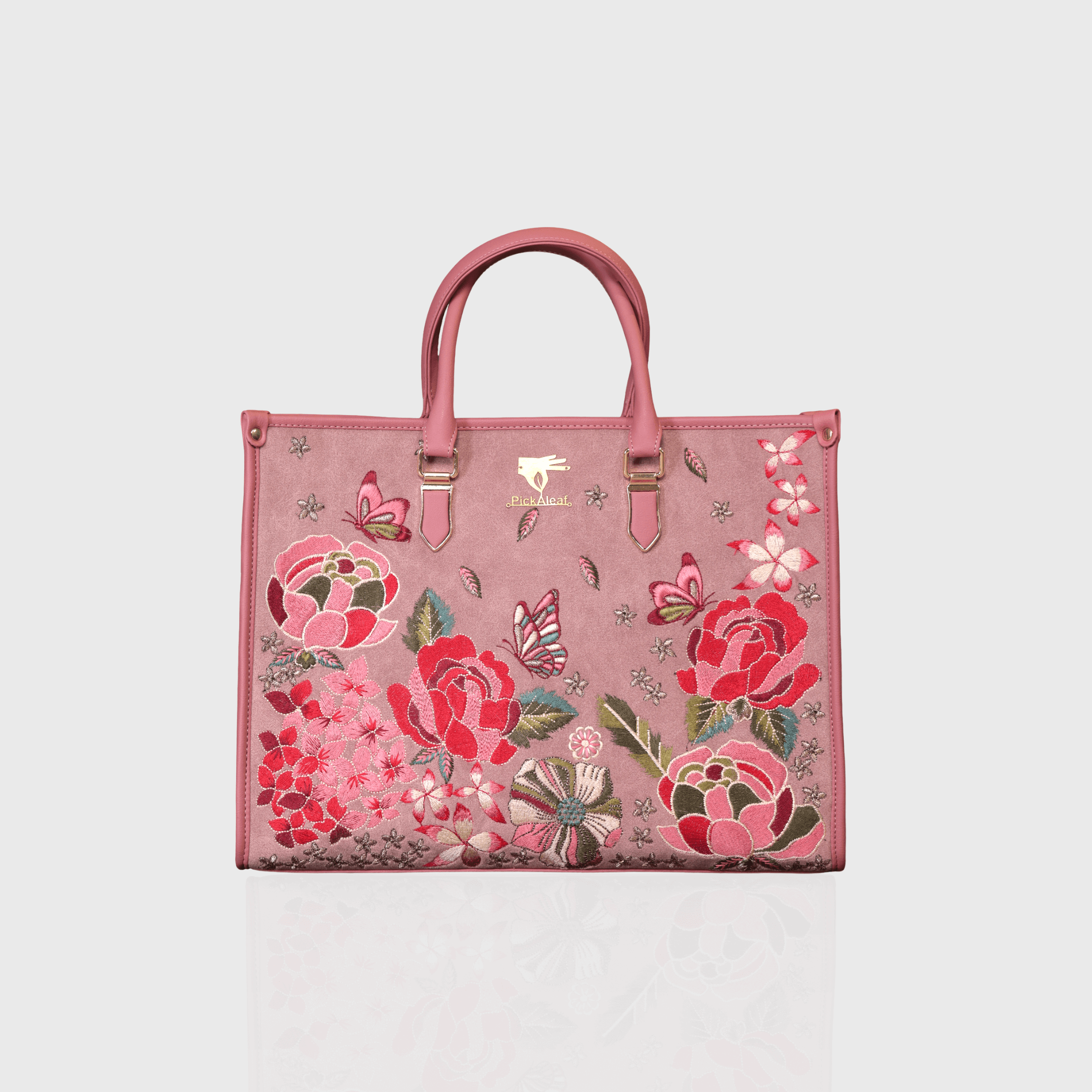 Pink vegan leather embroidered shoulder bag.