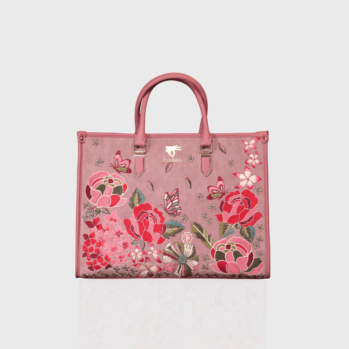 Pink vegan leather embroidered shoulder bag.